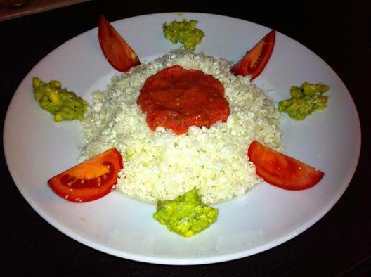 Cauliflower "rice" with tomato & date sauce at avocado & herbs cream.

I chopped the cauliflower with my blender at low speed, made a sweet and delicious sauce out of some tomatoes and dates and finally made a thick cream out of an avocado halve, some Italian herbs and a tiny bit of pure water.