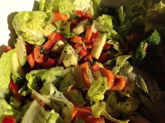 Creamy, sweet, tart and lush - carrots, zucchini, heart lettuce and yellow pepper with avocado cubes, lemon, some parsley and chives